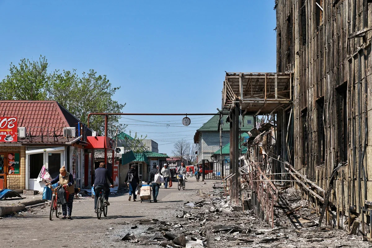 People walk past shops damaged by Russian shelling in Pokrovsk, Donetsk region, 23 April 2025. Photo: Nina Liashonok / Ukrinform / Rex Features / Vida Press