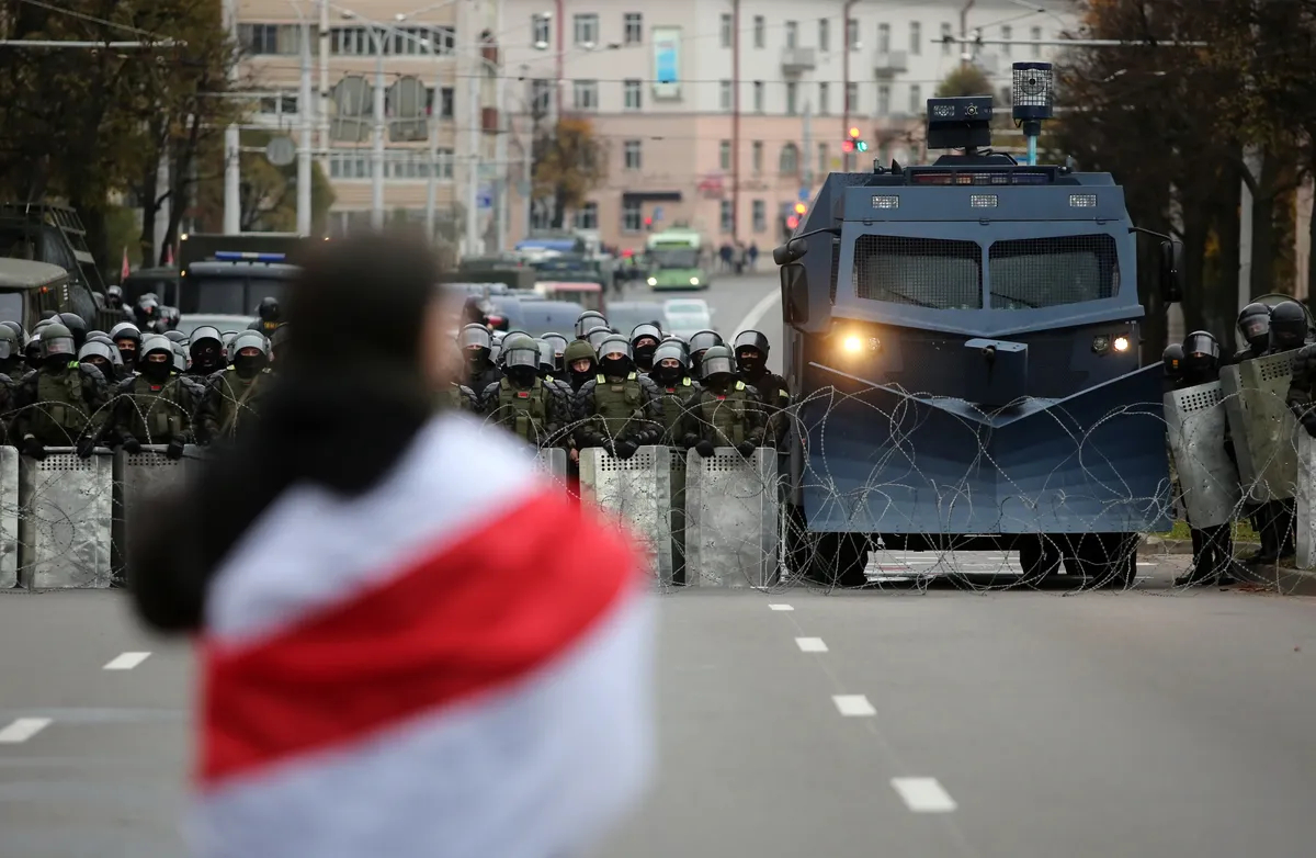 A protester faces ranks of Belarusian riot police and a water cannon during an anti-government rally in Minsk, Belarus, 25 October 2020. Photo: EPA